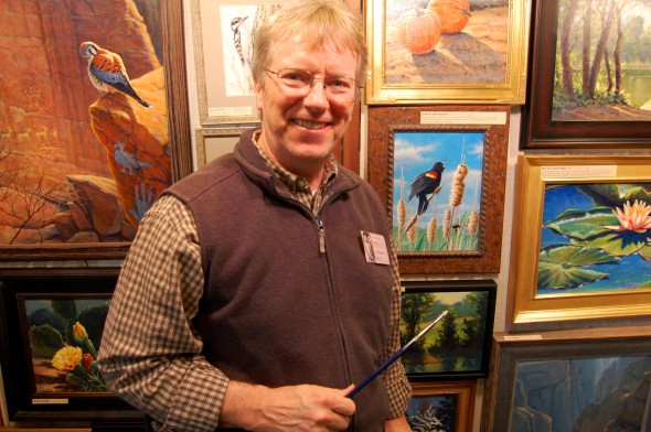 Jim Glover, who has worked with the Ohio Department of Natural Resources, shows off his paintings (photo by Aaron Zaremsky)