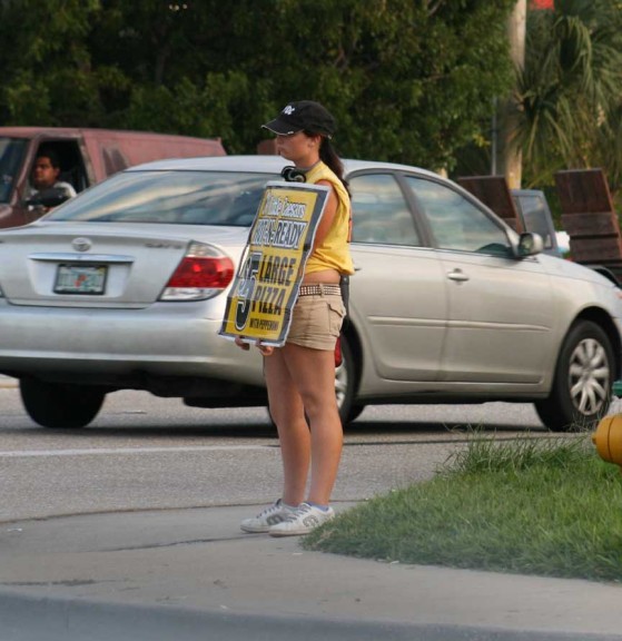 Pizza is a notable exception to the common aversion to purchasing things advertised on cardboard signs by the road. (Photo by Willie Lunchmeat)