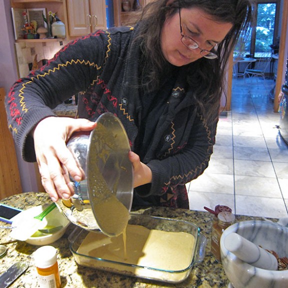 pouring in the pumpkin mixture