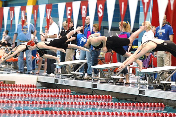 Erika Chick, second from right, took off from the starting block in the 200-yard freestyle race at last Saturday’s district finals in Oxford. Chick finished in second place with a season-best time of 1:52.17 in the event, which earned her an automatic state berth. Elizabeth Malone placed first and fourth in her races and will also swim at the state finals this week. (Photo by megan Bachman)