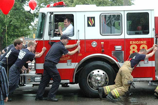 At Tuesday's open house, Miami Township firefighters carried on the tradition of pushing the new firetruck into its bay at the station. Assistant Chief Denny Powell drove the truck.