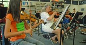 Christina Brewer, age 14, and Shirely Mullins play the violin part of a Russian folk song during rehearsal on Tuesday.