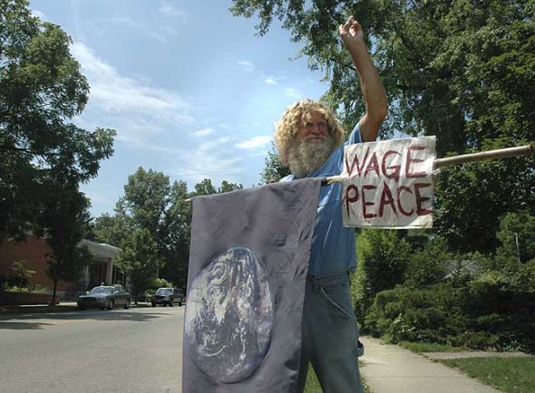 The late Terry Snider was among many protesters who stand at the corner of Xenia Avenue and Limestone Street every Saturday to oppose U.S. military action abroad. The informal group has gathered at that corner from noon to 1 p.m. since late 2002. (photo by Megan Bachman)