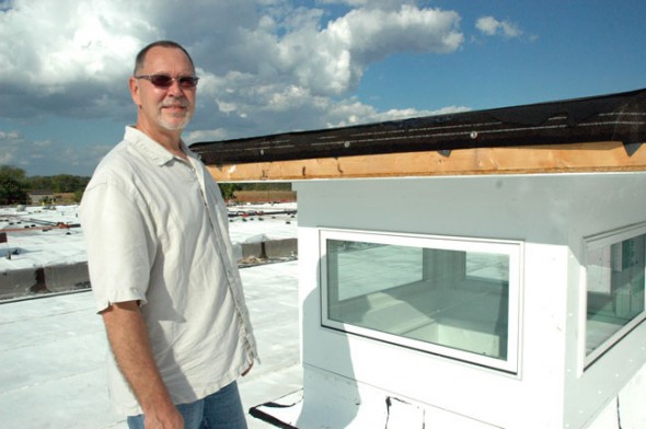 From the roof of the Greene County Career Center, Donnell stands before a skylight still under construction. This model, which does not have ventilation, costs $5,000. (Photo by Megan Bachman)
