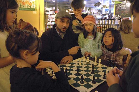 Check, mates!— Omar Durrani coached local chess enthusiasts on the smart moves at the Emporium last Sunday over a game between Amelie Maruyama, left, and Olivia Ling. Observing and trying so hard not to give away the answers were from left, Zenya Miyazaki, Jacob Woodburn, Eliana Ling and Kai Maruyama. (Photo by Lauren Heaton)