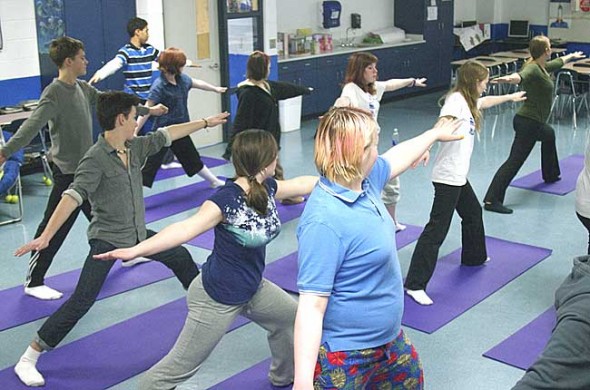 This month local yoga instructors Jen Ater, above, top right, and Gail Lichtenfels launched a program to teach yoga in village public schools. Shown above are McKinney Middle School students at a yoga class this week. (Photo by Sehvilla Mann)