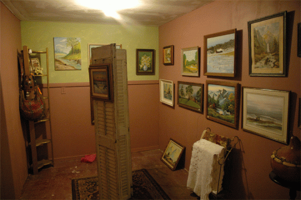 A gallery room features painting and antiques.