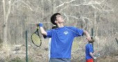 Aldo Duque tossed up the ball for a serve as the second singles player for the Bulldogs in the team’s loss last Friday to Miami Valley. In the background is the second doubles team of Nick Sontag and Quinn Levanthal, who won in straight sets. (Photo by Megan Bachman)