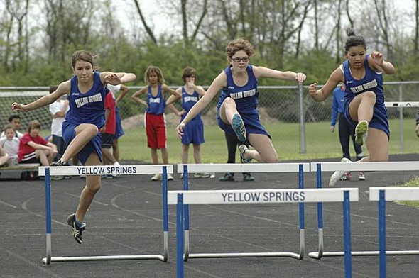 Rhona Marion won the 100-meter hurdles and the McKinney girls crown at the intermural meet last Saturday. Leaping, from left, are Ashlyn Burch, Marion and Ashley Longshaw. (Photo by Megan Bachman)