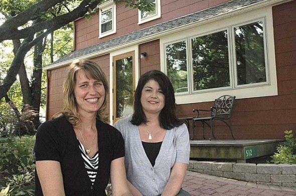 Ten years ago Naomi Ewald-Orme, left, founded Adoption Link, which now places about 60 children with adoptive families each year. She’s shown with social worker Patti Belliveau in front of the organization’s Dayton Street offices. (Photo by Lauren Heaton)