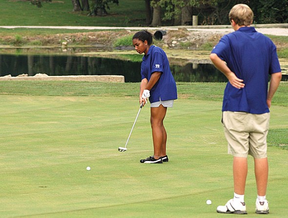 YSHS freshman Taylor Beck putted for bogey at the par three second hole at Locust Hills Golf Course in Springfield last week, while teammate Liam Weigand cheered her on. Beck scored 66 over nine holes as the YSHS golf team (1–2) lost the match to Dayton Christian 209–170. (Photo by Megan Bachman)