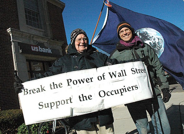 Village resident Eric Wolf, right, organized an Occupy protest in Yellow Springs last Friday in front of US Bank on Xenia Avenue to criticize the bank’s practices. Bill Houston, left, was one of the 34 local people who raised their voice with Wolf to draw attention to wealth disparity and economic injustice in the U.S. (Photo by Megan Bachman)