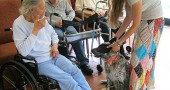 Friends Care Community residents meet a therapy dog. (Staff archive photo, 2012)