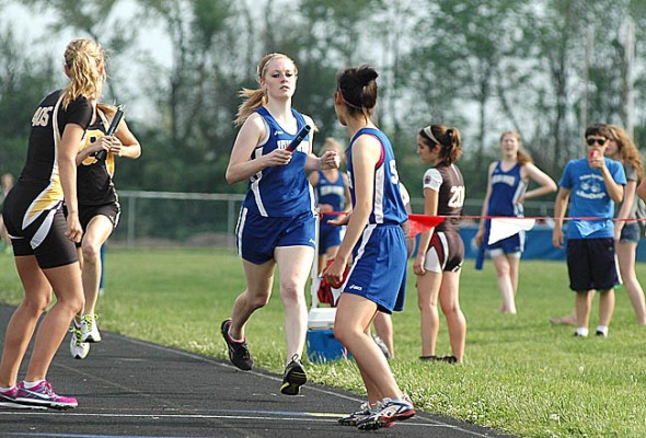 Nicole Worsham finished her leg of the 4x800-meter relay race before passing the baton to fellow YSHS runner Rikako Kida at last week’s Bulldog Invitational. The relay team, which also included Lois Miller and Alex Brown, won the event in 10:49.91, nearly 10 seconds ahead of higher-ranked opponents, Shawnee Springfield. (Photo by Megan Bachman)
