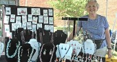 Villager Dinah Anderson, shown displaying her original jewelry, was one of several local artists selling their wares at the 2011 Art on the Lawn. This year’s event, sponsored by the Village Artisans, will take place this Saturday, Aug. 11, from 10 a.m. to 5 p.m. on the lawn in front of Mills Lawn School. (photo by Diane Chiddister)