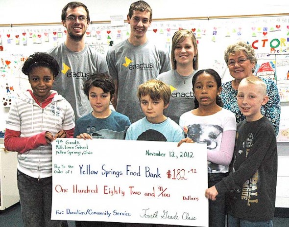 The fourth-grade class at Mills Lawn school proudly presented a check to the Yellow Springs Food Bank this week for $182.92. (Photo by Lauren Heaton)