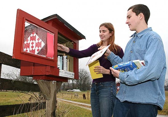 On Sunday Regina Brecha and Max Mullin restocked the Mullin family’s Little Free Library on State Route 370. (Photo by Suzanne Ehalt)