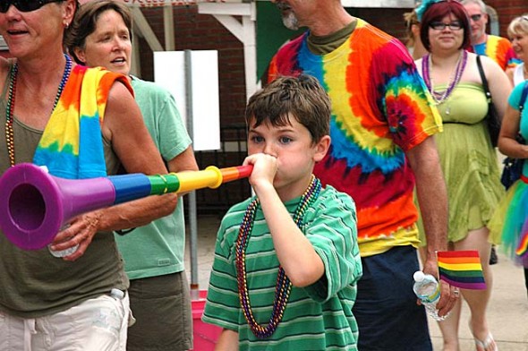 The second annual Yellow Springs Pride Weekend, June 14–16, will feature a sidewalk parade, educational talks and booths, late night parties with live music, DJs and drag troupes and a family-friendly potluck picnic. Here, Liam Hackett marched in last year’s Sidewalk Pride Walk, which drew 200 participants. (File photo by Lauren Heaton)