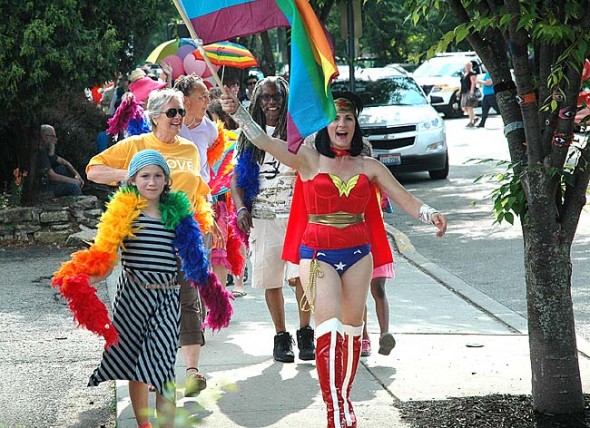Isaiah Crawford, front left, led Saturday’s Pride Parade through the village with Melissa Heston in Wonder Woman reprise flying her colors. Joan Chappelle, Ona Harshaw, and John Booth followed, trailed by a multi-block line of about 200 participants. (Photo by Lauren Heaton)