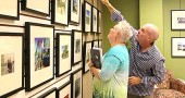 Photographer Andy Snow points out a photo to Antioch University Midwest President Ellen Hall from his exhibit on the 100-year anniversary of the Dayton flood, which is currently on exhibit in the AUM lobby. The exhibit, which opened last Saturday, runs through October. (Photo by Suzanne Szempruch)