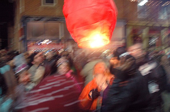 A red lantern bounces among the crowd of revelers New Years Eve on Xenia Avenue. (Photo by Matt MInde)