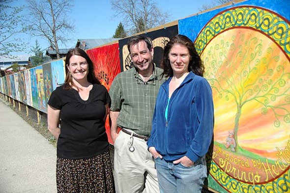 Holly Underwood of the Yellow Springs Arts Council, who organized the Fence Gallery at the Barr property, is shown with two participating artists, Scott Stolsenberg and Bettina Solas. The project, which was the brain child of property owner Jim Hammond, will be up until the fall. (photos by Lauren Heaton)
