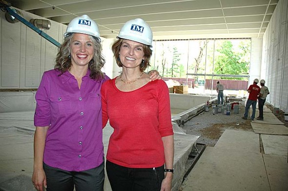 Newly hired Antioch College Wellness Center Director Monica Hasek, left, and Project Lead Dorothy Roosevelt beside the center’s almost-completed pool, in the natatorium that features a wall of windows on the south side, with a patio beyond. The center is scheduled to be completed in late summer or early fall. (Photo by Diane Chiddister)