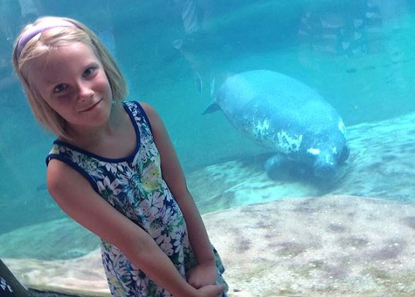 Mackenzie Horton, age 9, is raising money to help rehabilitate manatees, which are often injured by boats. She's shown at the Columbus Zoo.