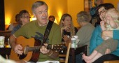 Dave Younkin of the bluegrass band Mad River Railroad took part in a recent Monday morning bluegrass jam at the Emporium. Tanya Maus, with her son August, joined in the singing. (photo by Carol Simmons)