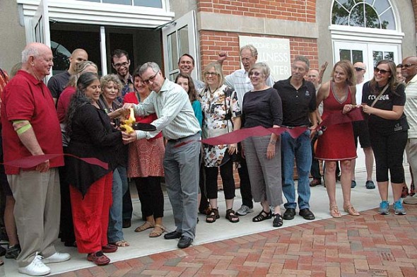 College President Mark Roosevelt cut the ribbon, with the help of Chamber of Commerce President Lisa Goldberg and Village Council President Karen Wintrow, while Mayor Dave Foubert, left, looked on.