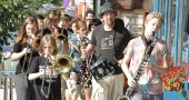 The Friends Music Camp Street Band marched a quick downtown loop Saturday afternoon to announce their concert that evening, “Musicians for Justice and Peace,” which benefited Glen Helen. (Photo by Matt Minde)