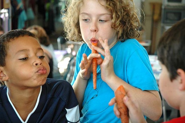 Antioch School students Antonio Chaiten, left, and Lucy Dennis participated in a two-day workshop on how to make pennywhistles out of carrots. (photo by Carol Simmons)