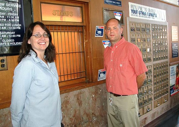 Postmaster Ken Hensley joined the Yellow Springs post office this summer, working alongside longtime local postal clerk Molly Panstingel.  (Photo by Lauren Heaton)