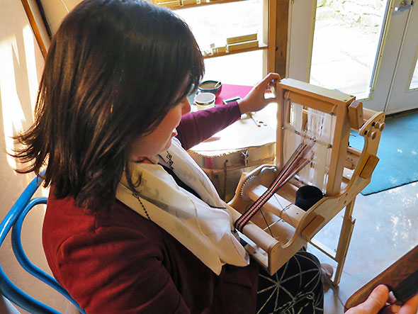 Jodie Erickson Gollings of Red Hen Designs working on a strap at the loom