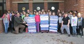 Mills Lawn School third graders proudly presented banners they’d woven from recycled materials to Principal Matt Housh. (Submitted photo courtesy of Mills Lawn School)