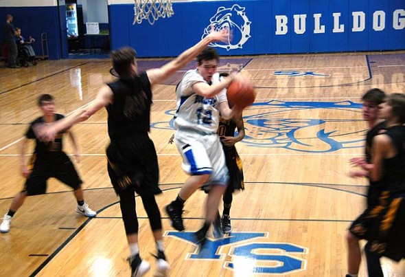 Senior Ethan Dewine (#12) blurs the boundaries of time and space as he breaks through Dayton Christian’s defensive wall during the Bulldog’s home game on Jan. 29. The Bulldogs won 60-49, clinching the Metro Buckeye Conference championship and bringing the Bulldog’s conference record to 10-0.  (Photo by Dylan Taylor-Lehman)