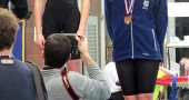 Bulldog swimmer Olivia Chick beamed proudly after receiving a bronze medal for her impressive finish in the 100 freestyle in the State Swimming Championship, held in Canton on Feb. 25 and 26. Chick and fellow Bulldog Aman Ngqakayi represented the school (and village) in the tournament, setting both school and personal records in the process. (Submitted Photo)