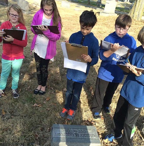 Mr. Knostman’s fourth-grade class at Mills Lawn School is working on a project to improve the Glen Forest cemetery by adding a memory bench. Students here are shown mapping the project. (Submitted  Photo)