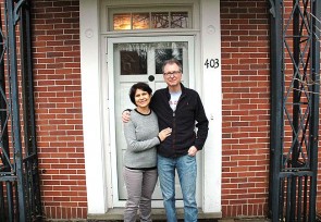 Antioch College’s new president, Tom Manley, started at the college on March 1, replacing Mark Roosevelt, who left at the end of 2015. Manley is pictured here with his wife, Susanne Hashim, in the doorway of their home, the Folkmanis House on President Street. The couple moved to Yellow Springs with their young daughter, Chedin.  (Photo by Audrey Hackett)