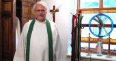 St. Paul Church’s new pastor, Father John Krumm, stood in the local church’s vestry after mass on a recent morning. Krumm, who also leads churches in Xenia and Jamestown, began a six-year appointment at St. Paul on July 1, replacing former pastor Father Anthony Geraci. Some parishioners hope Krumm will help heal divides the local church community has suffered in recent years. (Photo by Audrey Haclett)