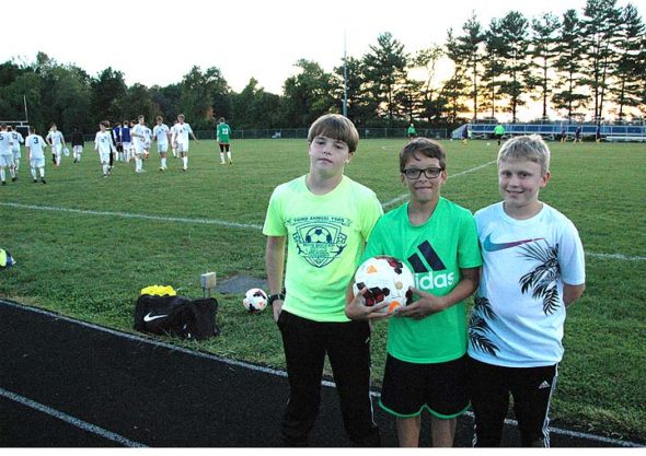 Ball boys Jason Knemeyer, Eli Eyrich and Josh Clark stood at attention at the Bulldogs game against the Columbus International Lions. The ball boys were tasked with patrolling the perimeter of the game and throwing balls to the players or referees when it was needed. They also filled this reporter in on the strategy of the game, which the Bulldogs won 7–1. (Photo by Dylan Taylor-Lehman)