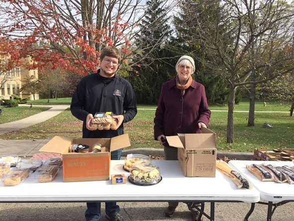 The Dayton Foodbank’s Andy Macy and Yellow Springs resident and volunteer Susan Pfeiffer distributed food items in Yellow Springs last month as part of the Foodbank’s mobile pantry. The pantry stops every fourth Tuesday of the month in Yellow Springs, and aims to provide food items to the quarter of the Yellow Springs population that qualifies to receive it. (Submitted photo)