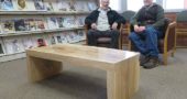 Local woodworker Tom Hawley and local arborist Bob Moore recently sat in front of the new table Hawley made for the Yellow Springs library’s periodical room. The table was made with local wood harvested by Moore from ash trees, which were felled by the Emerald Ash Borer. (Submitted photo)