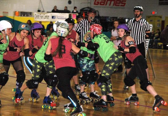 Teammates from the Bully Frogs and Murder Squad clashed at a recent Gem City Roller Derby match, an area derby league that boasts a significant Yellow Springs presence. Many villagers are newcomers to the sport but have quickly taken to its camaraderie and particular brand of athleticism. (Photo by Dylan Taylor-Lehman)