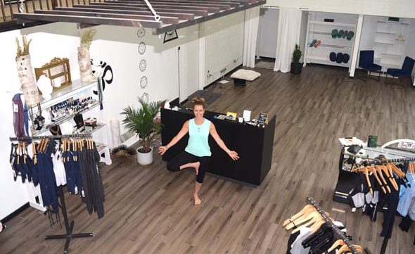 House of AUM, the Kings Yard yoga shop, expanded to the former home of Rita Caz in June. Pictured here in the renovated space is owner Melissa Herzog. The business recently received a Village Inspiration and Design Award, or VIDA, for its new look. (Photo by Jessica Sees)