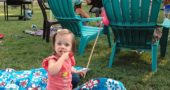 Best to start them young! One of the youngest block party revelers — Juniper DeVore Leonard, almost 2 — enjoyed her moment in the sun, and on a blanket, at the Whiteman/Davis Triangle party on Sunday, Aug. 27. (Photo by Carol Simmons)