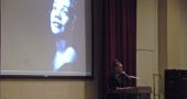 Tamika Mallory, co-president of the Women’s March, stands in front of a projected photograph of Coretta Scott King, Antioch alumna. Mallory gave a talk at Antioch College on April 26, the day after she received the second annual Coretta Scott King Legacy Award. She told the audience that the struggle for civil rights continues and that fighting systemic racism is everyone’s responsibility. (Photo by Megan Bachman)