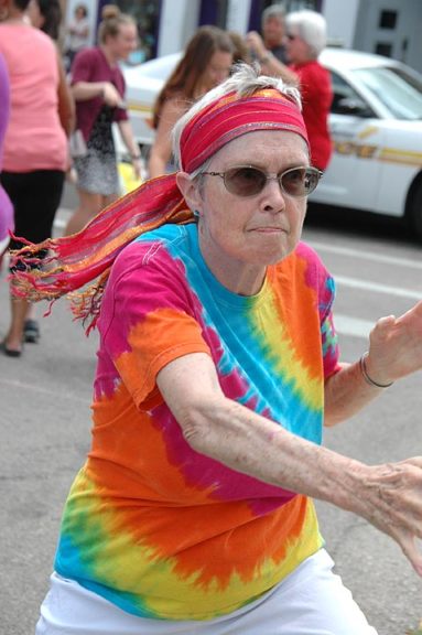 Celia Diamond beckoned onlookers to join in the fun at the annual Senior Center flash mob dance on Wednesday, May 30. (Photo by Lauren ‘Chuck’ Shows)