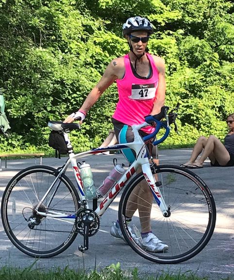 Villager Diana Castellano, pictured here in a recent race, has qualified to compete in multiple biking and swimming events as well as the triathlon competition at the 2019 National Senior Games, popularly called the Senior Olympics, to be held in June in Albuquerque, N.M. Longtime Yellow Springs resident Cheryl Meyer, not pictured, qualified to compete in four swimming events. Both women swim with the Dayton Sharks team. (submitted photo)