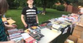 Ember McDonald of Yellow Springs browsed through used books and CDs at the 38th annual YS Book Fair, held last weekend at Mills Lawn. (Photo by Carla Steiger)